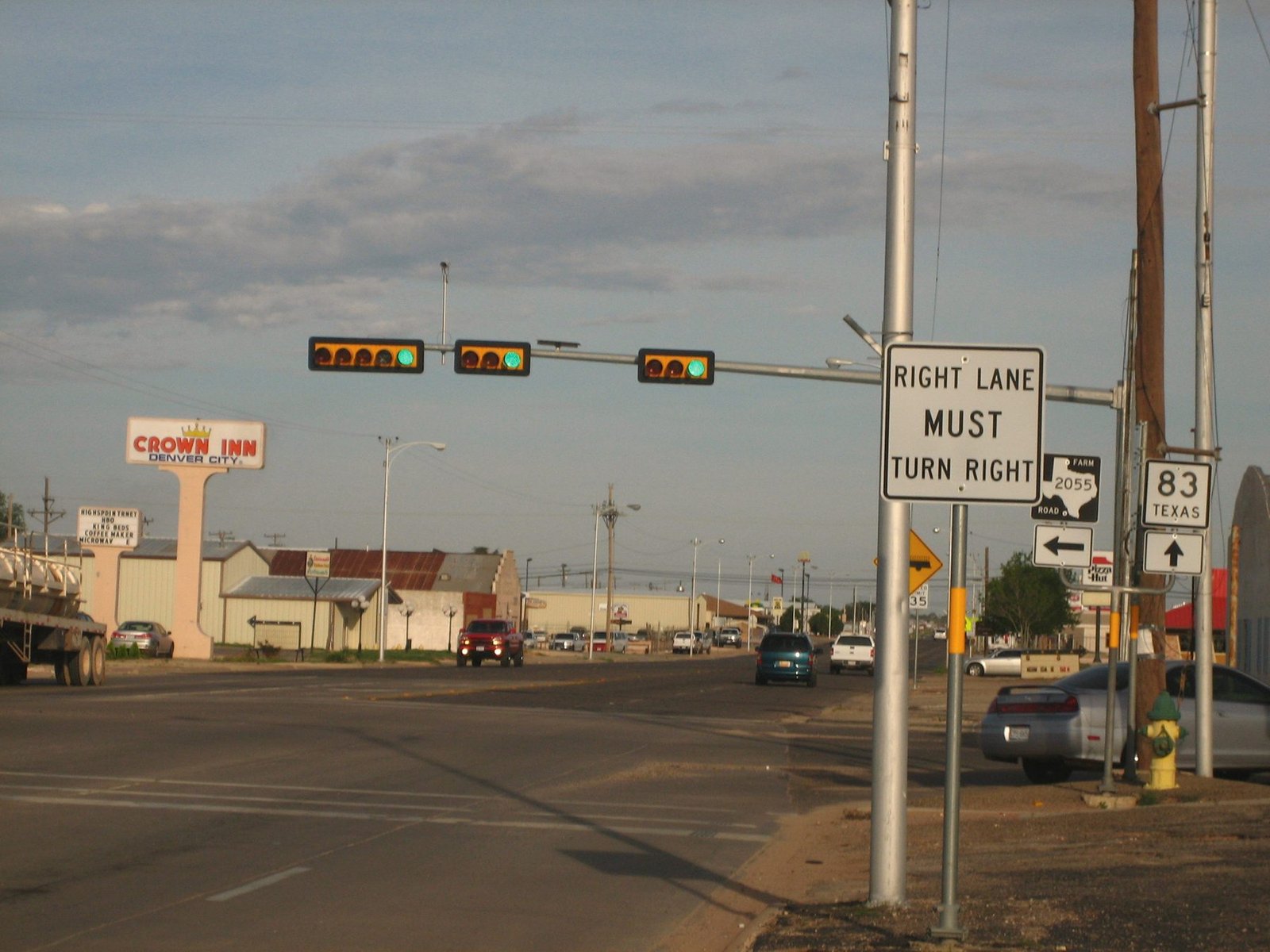 A Denver City intersection with a Texas 83 highway sign and a traffic signal